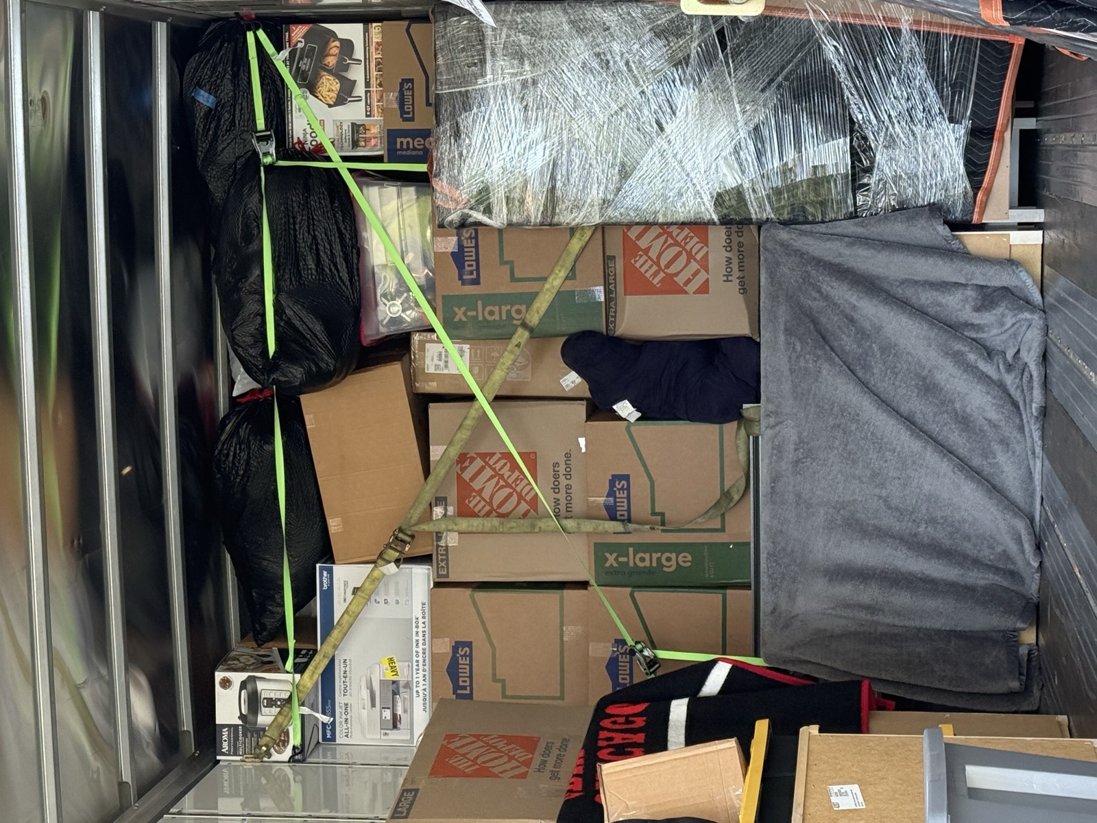 Boxes and furniture secured with tie-down straps inside a long-distance moving truck across MD, DC and VA